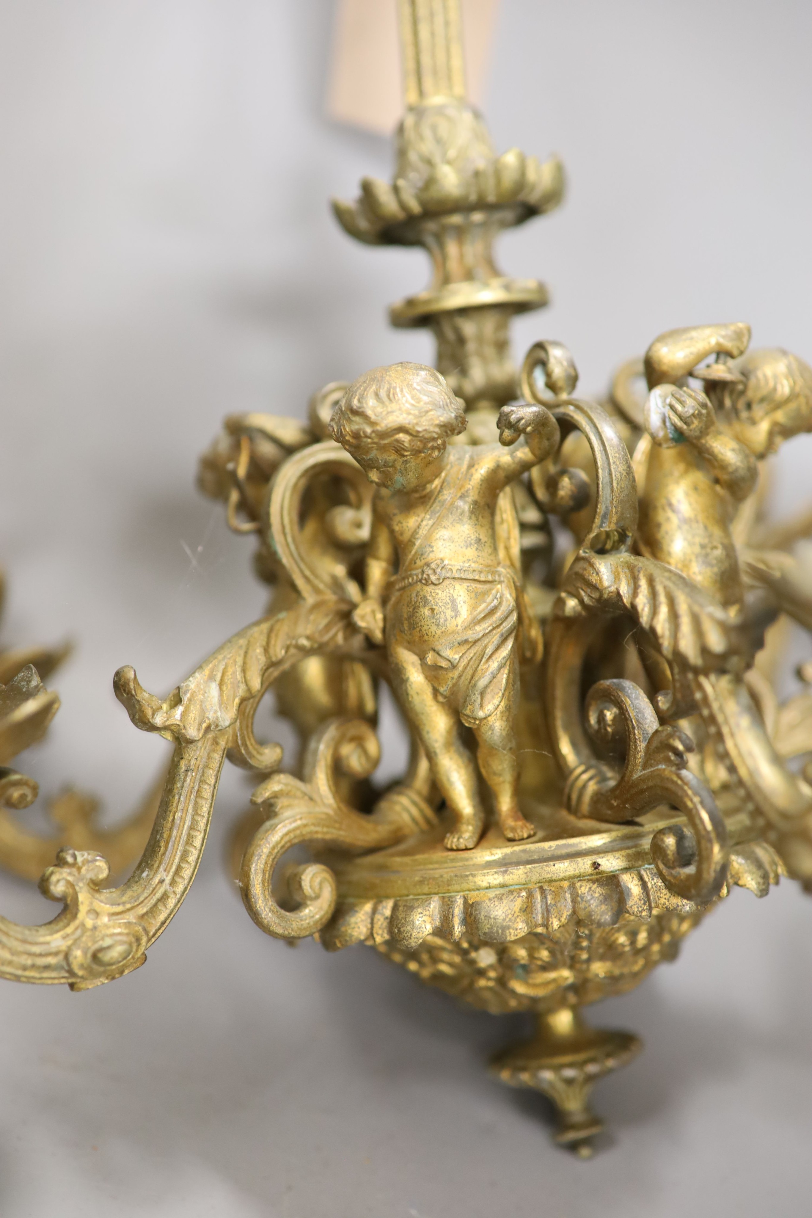 Two brass cylindrical hall lanterns, tallest 49 cm and a figural gilt metal chandelier